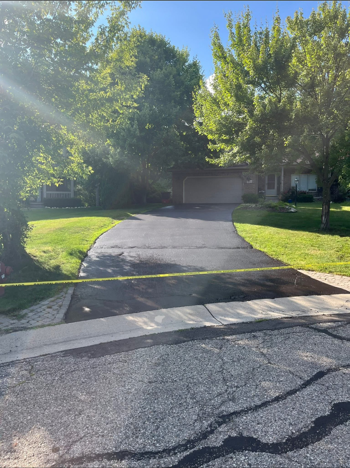 Sealcoated suburban driveway with home